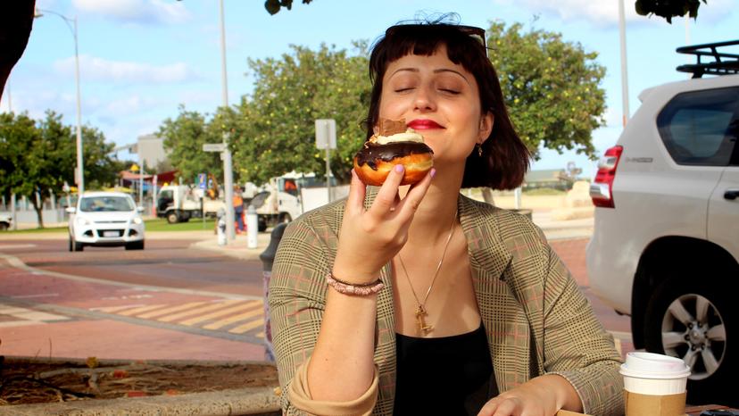 Lisa Favazzo savouring a donut in the sunshine. 